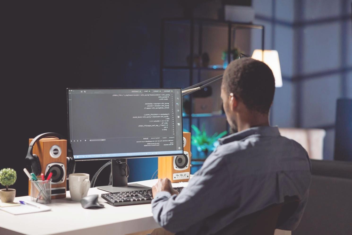Mobile game development workspace showing code and testing devices